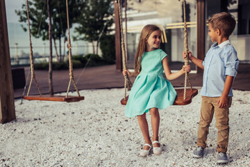 Cheerful children on swing
