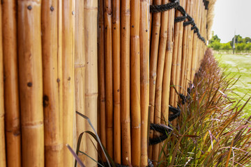 Bamboo fence with grass for home decorate design.