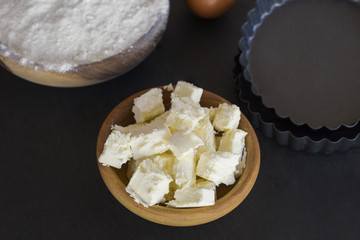 flour and ingredients on black table. Top view