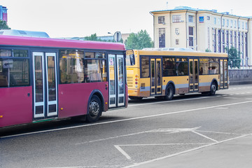 Fototapeta na wymiar two buses go on city street