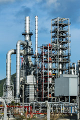 Refinery tower in petrochemical industrial plant with blue sky
