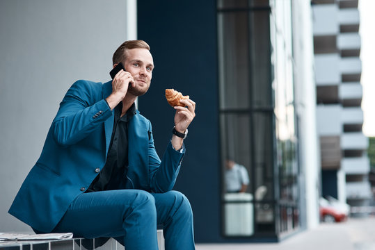 Handsome young businessman talking on phone - Powered by Adobe