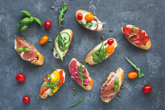 Traditional spanish tapas on dark background. Flat lay, top view