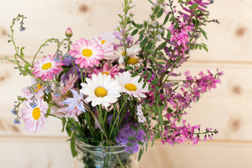 Close up of white daisies in purple and pink spring flower bouquet (selective focus)