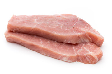 Fresh pork fillet with basil on a white background.