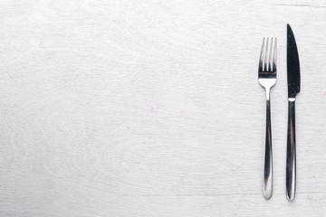 Cutlery on a wooden background. Top view. Free space for text.