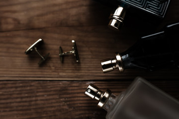 Stylish mens business accessories: cologne and cufflinks - obrazy, fototapety, plakaty