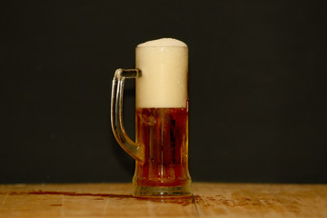 beer in a mug on wooden