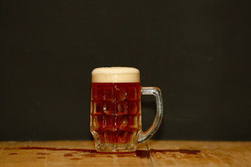 beer in a mug on wooden table