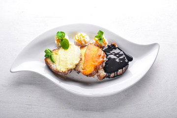 Biscuit pastry with caramel and chocolate sauce. On a wooden background. Top view. Free space for text.