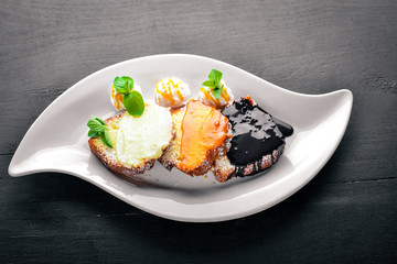 Biscuit pastry with caramel and chocolate sauce. On a wooden background. Top view. Free space for text.