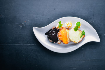 Biscuit pastry with caramel and chocolate sauce. On a wooden background. Top view. Free space for text.