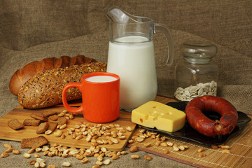 Jug with a milk mug, cheese and sausage