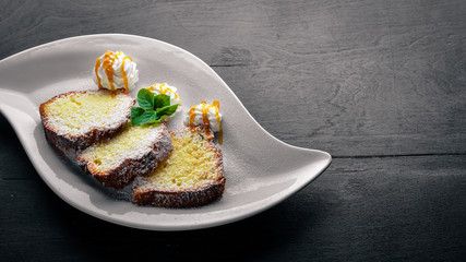 Biscuit pastry with caramel and chocolate sauce. On a wooden background. Top view. Free space for text.