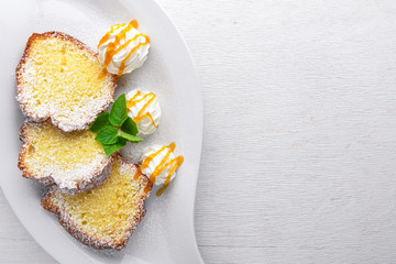 Biscuit pastry with caramel and chocolate sauce. On a wooden background. Top view. Free space for text.
