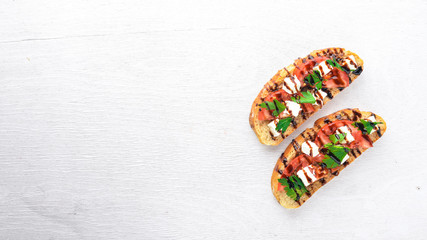 Tomato sandwich and feta cheese. On a wooden background. Top view. Free space for text.