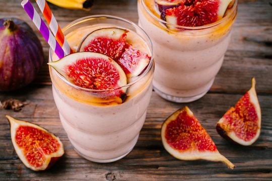 healthy breakfast smoothie with fresh figs, banana and honey in glasses
