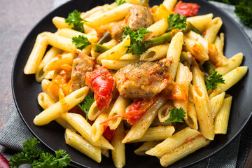 Pasta penne with meat and vegetables.