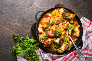 Stewed pork with vegetables in tomato sauce.