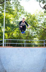 Young man doing parkour tricks in extreme sports park