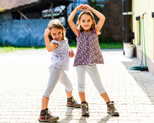 Children - twin girls are going hiking in the mountains.