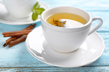 Beautiful composition with cup of cinnamon tea on wooden table