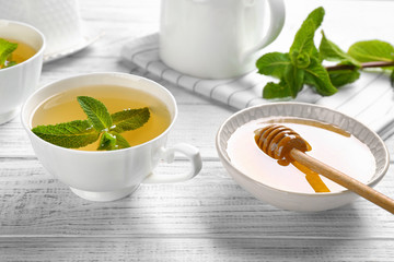 Beautiful composition with cup of cinnamon tea on wooden table
