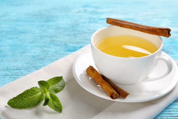 Cup of tasty cinnamon tea on wooden table