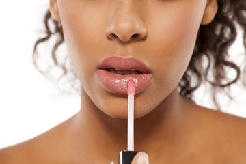 young beautiful black woman applied lipstick - Powered by Adobe