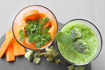 Fresh juices in glasses and ingredients on slate plate