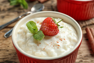 Creamy rice pudding with strawberry, closeup