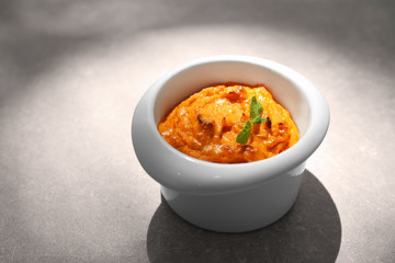 Ramekin with tasty carrot souffle on table