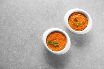 Ramekins with tasty carrot souffle on table