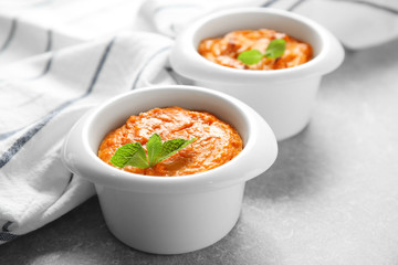 Ramekins with tasty carrot souffle on table