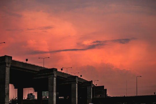 silhouette urban bridge after work with red twilight sky at the back