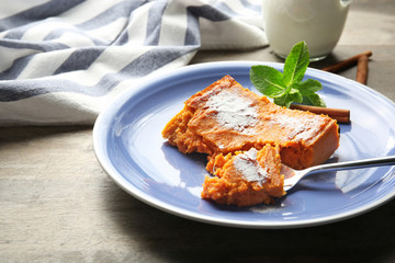 Plate with tasty carrot souffle on table