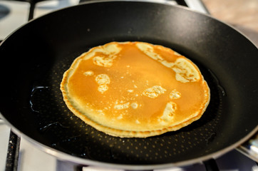 Cooking pancakes in a frying pan.