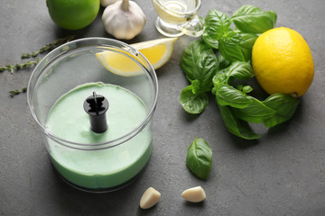 Tasty creamy lime sauce for fish taco in blender bowl on kitchen table