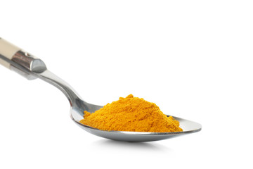 Turmeric in spoon on white background
