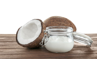 Coconut oil in mason jar on table against white background