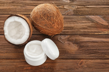 Coconut oil in jar on wooden background