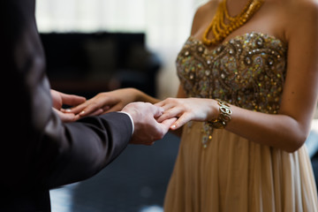 Guy and girl in beautiful clothes holding hands.