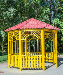 Yellow wooden gazebo in the park