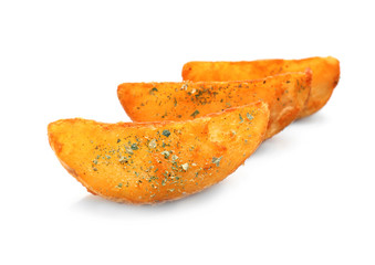 Delicious baked potato wedges on white background