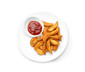 Plate with delicious baked potato wedges and sauce on white background