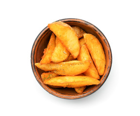 Bowl with delicious baked potato wedges on white background