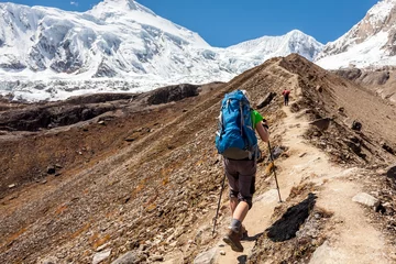 Cercles muraux Manaslu Hiker is climbig to Manaslu base camp in highlands of Himalayas on Manaslu circuit