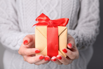 Female hands holding gift box, close up