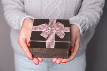 Female hands holding gift box, close up