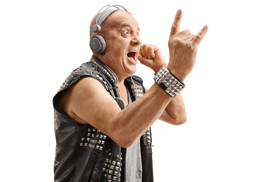 Elderly punker listening to music and making rock hand gesture
